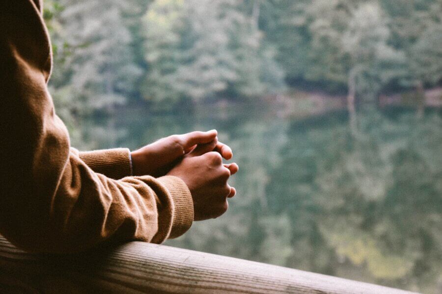 Woman looking outside of the window in mental health treatment inpatient